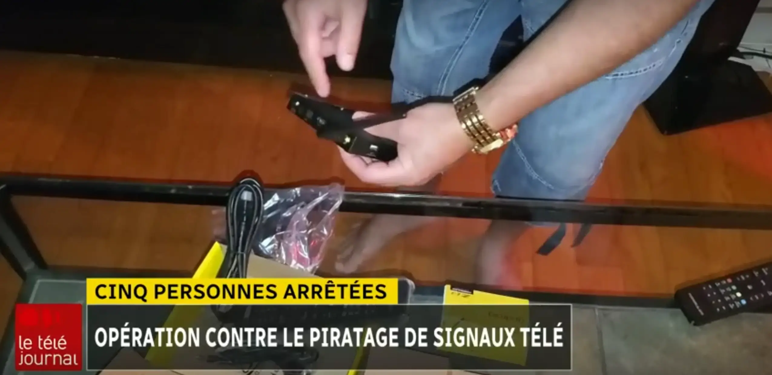 News footage showing Quebec police seizing IPTV devices during a raid on an illegal streaming operation